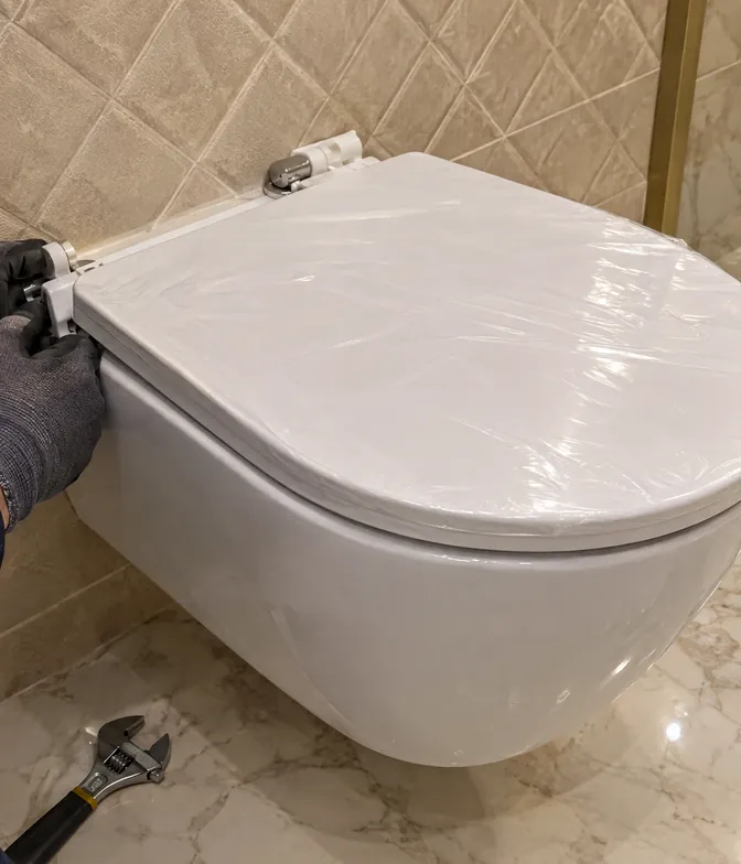 Yeni asma klozete yavaş kapanan kapak menteşesi takılıyor